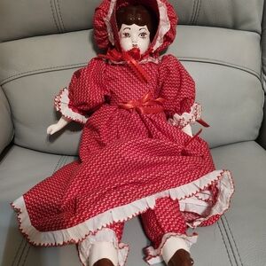 Red and White Porcelain Doll with Bonnet